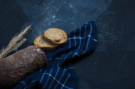 A loaf of fresh bread made from rye flour. Bread cut into slices.