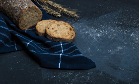 A loaf of fresh bread made from rye flour. Bread cut into slices.の写真素材
