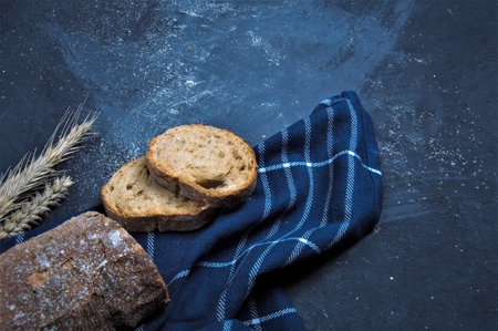Freshly baked rye bread lies on a dark blue background.の写真素材