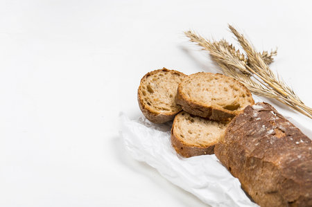 cut into slices of a loaf of dark bread made from rye flour lies