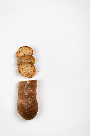 cut into slices of a loaf of dark bread made from rye flourの写真素材