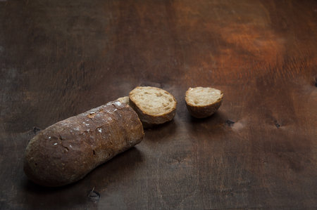 Wheat bread with a ruddy crust. On a warm wooden bright background.