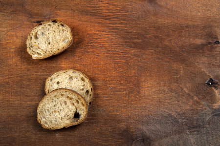 Wheat bread with a ruddy crust. On a warm wooden bright background.