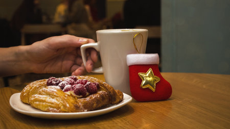 Coffee and dessert on a table in a cafe for christmas. Front view