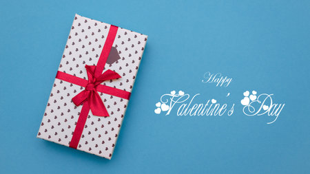 Concept for valentines day. Gift on a blue background. Inscription.