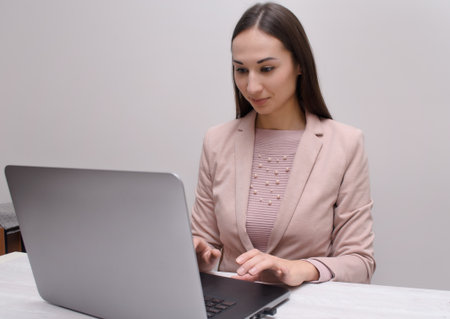 The girl works at the computer. White backgroundの写真素材