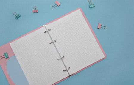 Open empty notebook on a blue background.