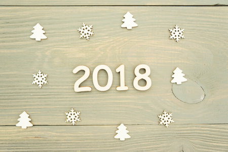 2018 the year of the wooden figures on wooden background and Christmas decorationsの写真素材