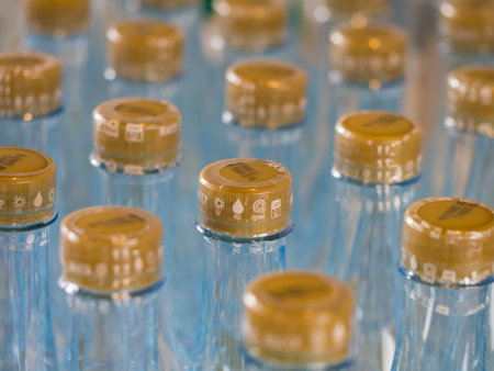 Water bottles with golden cap. Shallow Depth of Field.
