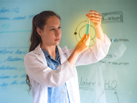 Attractive young beautiful scientist analyzing liquid reagent in laboratory.の写真素材