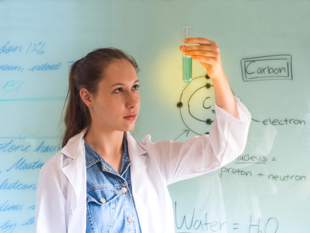 Attractive young beautiful scientist analyzing liquid reagent in laboratory.の写真素材