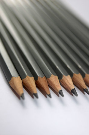 Detail image of a set of wooden graphite pencils set together in a row. Low angled image, shallow depth of field.の写真素材