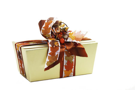 A gold decorated box of chocolates set on a white isolated background.の写真素材