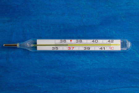 Mercury thermometer on a blue background.の写真素材