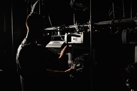 The lighting engineer repairs the light device on stageの写真素材