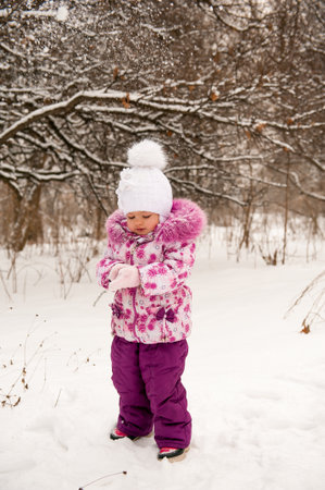 Mother and her little daughter enjoying beautiful winter dayの写真素材