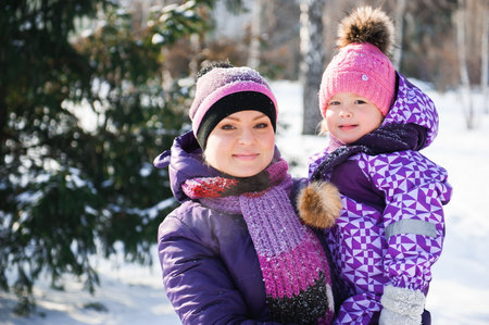 Mother and her little daughter enjoying beautiful winter day