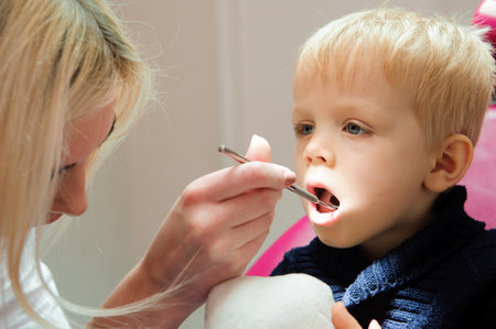 a child sitting in a chair dental, stomatologist.の写真素材