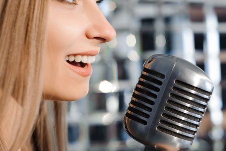 beautiful woman singing on the stage next to the microphone.の写真素材