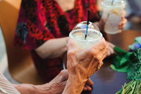 Happy elderly couple in love drinking lemonade in a cafe on the
