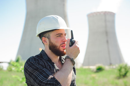 Portrait of a builder engineer with a radio set in his hand.