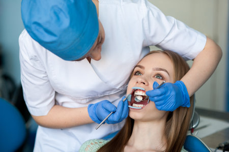 Dentist examining a patients teeth in the dental clinic.