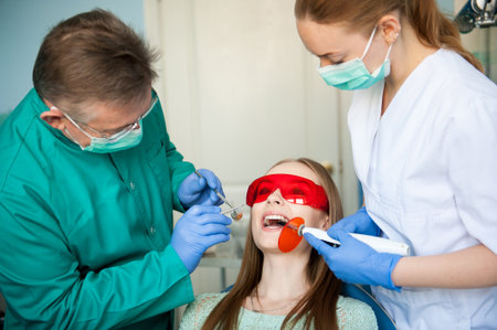 Dentist examining a patients teeth in the dental clinic.の写真素材