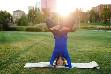 beautiful woman doing yoga exercises in the park