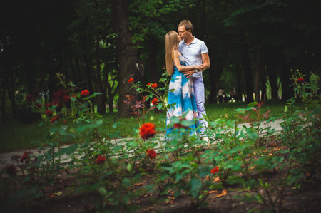 Pregnant woman with her husband in the park.の写真素材