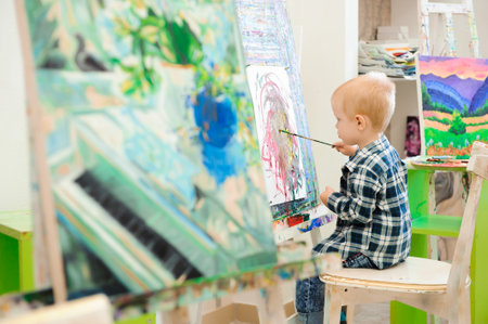 a child draws a picture paints on art lessonの写真素材