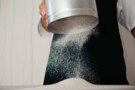 Making dough by female hands at bakeryの写真素材