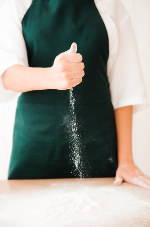 Making dough by female hands at bakeryの写真素材