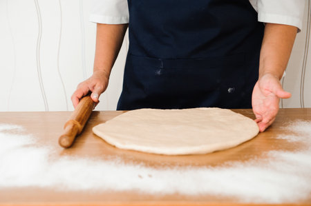 Making dough by female hands at bakery