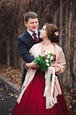 Portrait of happy newlyweds in autumn nature.の写真素材