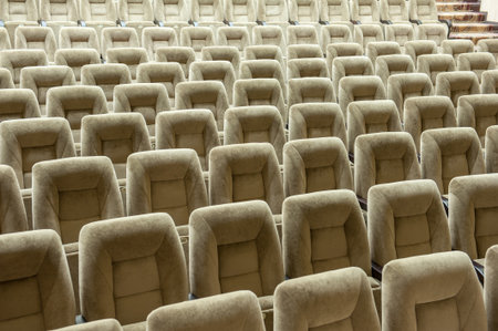 Empty auditorium with beige chairs, theatre or conference hall
