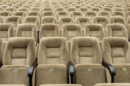 Empty auditorium with beige chairs, theatre or conference hallの写真素材