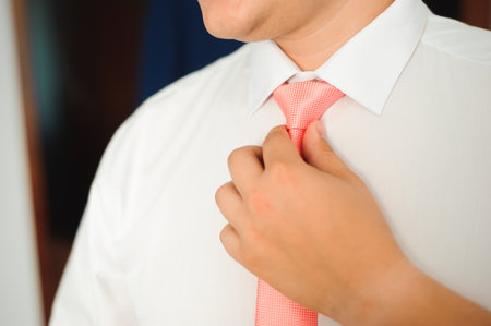 Young businessman puts a suit on before meeting with partners.の写真素材