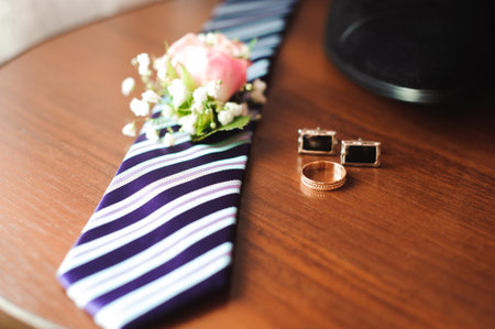 grooms wedding details, rings, perfume, tie, boutonniereの写真素材