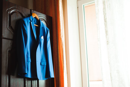 Young businessman puts a suit on before meeting with partners.の写真素材