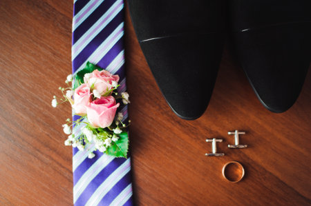 grooms wedding details, rings, perfume, tie, boutonniere