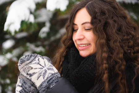 Happy young woman walking in winter time.の写真素材