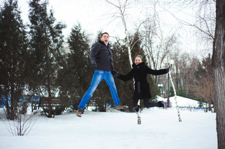 Young couple hugging and kissing in the Park in winter.の写真素材