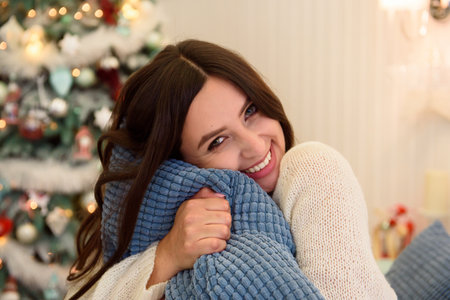 Holidays, celebration and people concept - young woman over christmas interior background.の写真素材