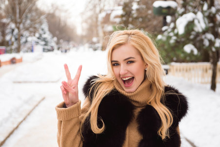 Beautiful young blonde woman in winter parkの写真素材