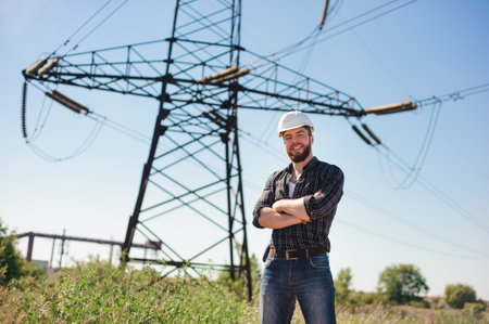 Engineer with white hard hat under the power lines.Engineer work at an electrical substationの写真素材