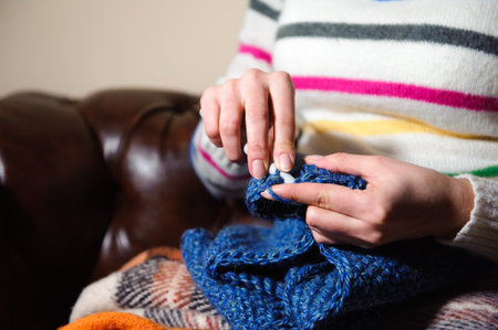 Women's hands knitting. Close up of hands knitting. Process of knitting.