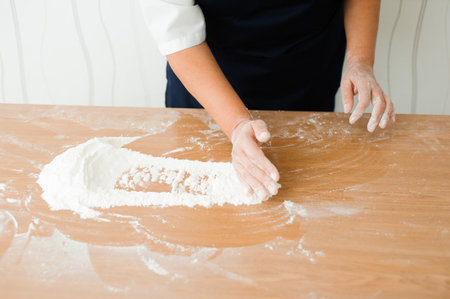 Chef preparing dough - cooking process, work with flourの写真素材