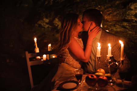 Romantic dinner of a young couple by candlelight in the mountains.の写真素材