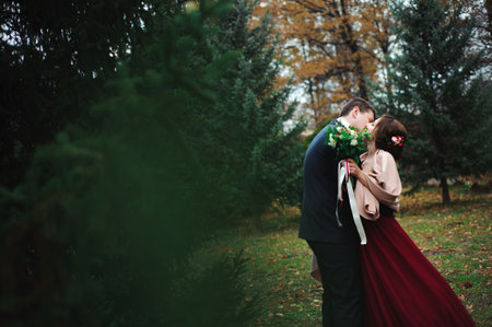 Romantic embrace of newlyweds. Couple walks in the park.の写真素材