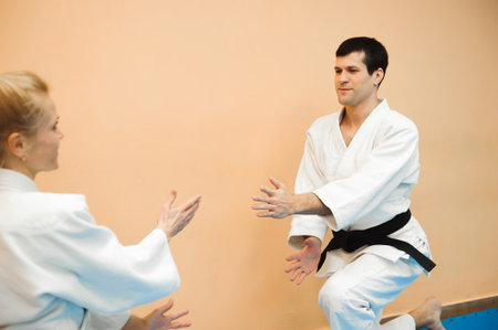 Man and woman fighting at Aikido training in martial arts schoolの写真素材